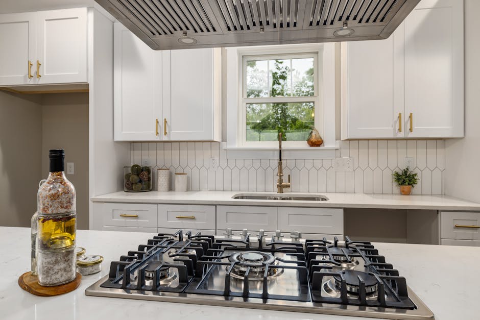 Contemporary kitchen interior showcasing a sleek gas stove and bright cabinetry, perfect for home design inspiration.